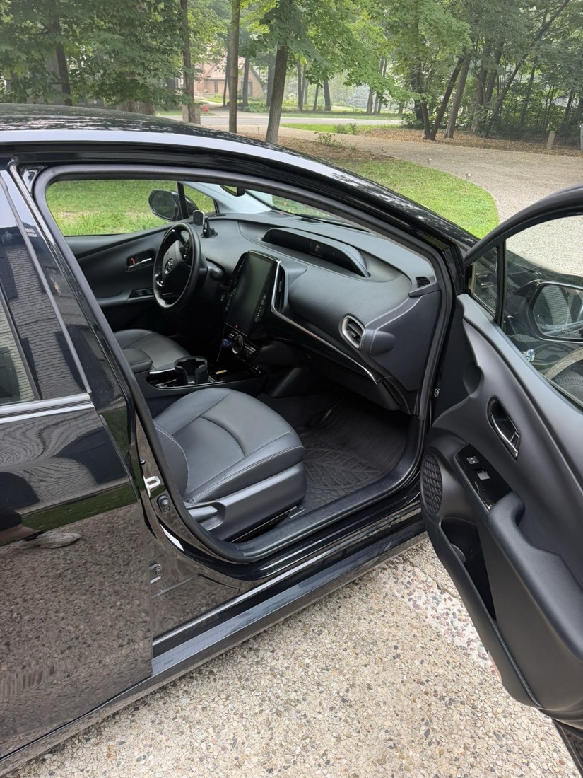 Detailed front seat and dashboard of a black Toyota Prius